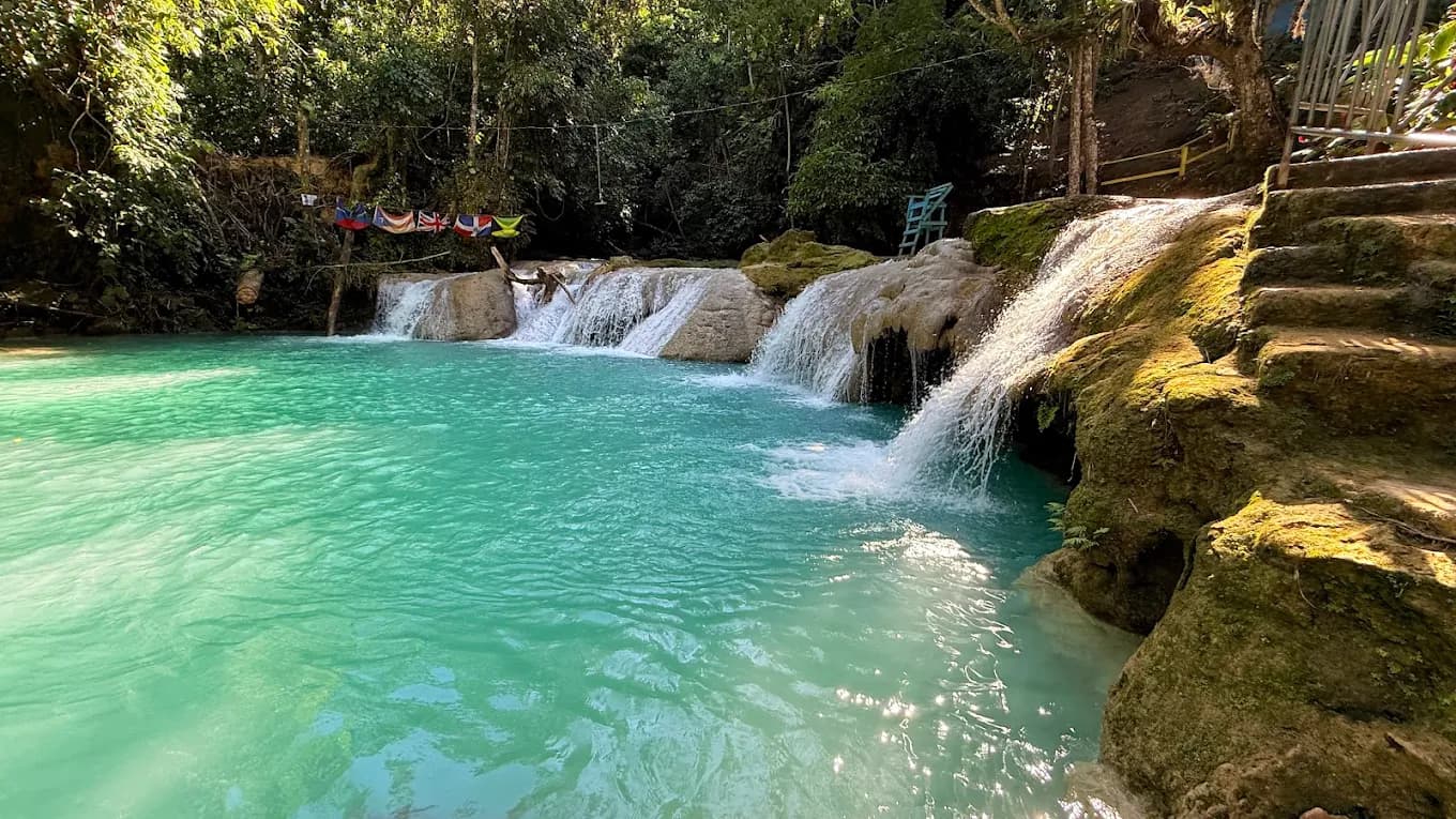 Blue Hole in Jamaica with people swimming and cliff jumping